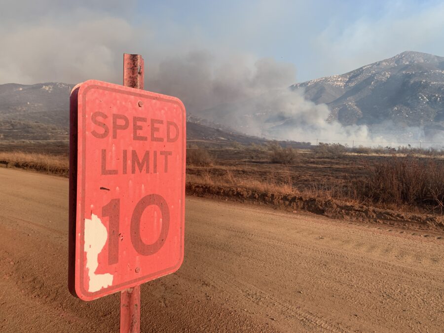Fire retardant covers a road sign on Barrett Lake Road in the eastern San Diego town of Dulzura, California, site of the Border 32 Fire that burned 4,456 acres between August 31 and Sept 8, 2022. Photo Credit: Josh Stotler