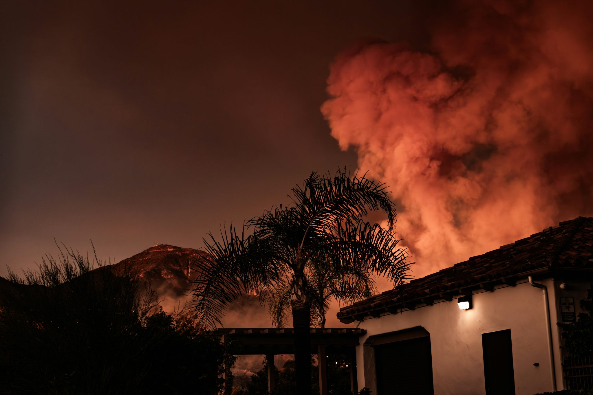 LA wildfires fanned by high winds as fire, snow and ice compete for ...